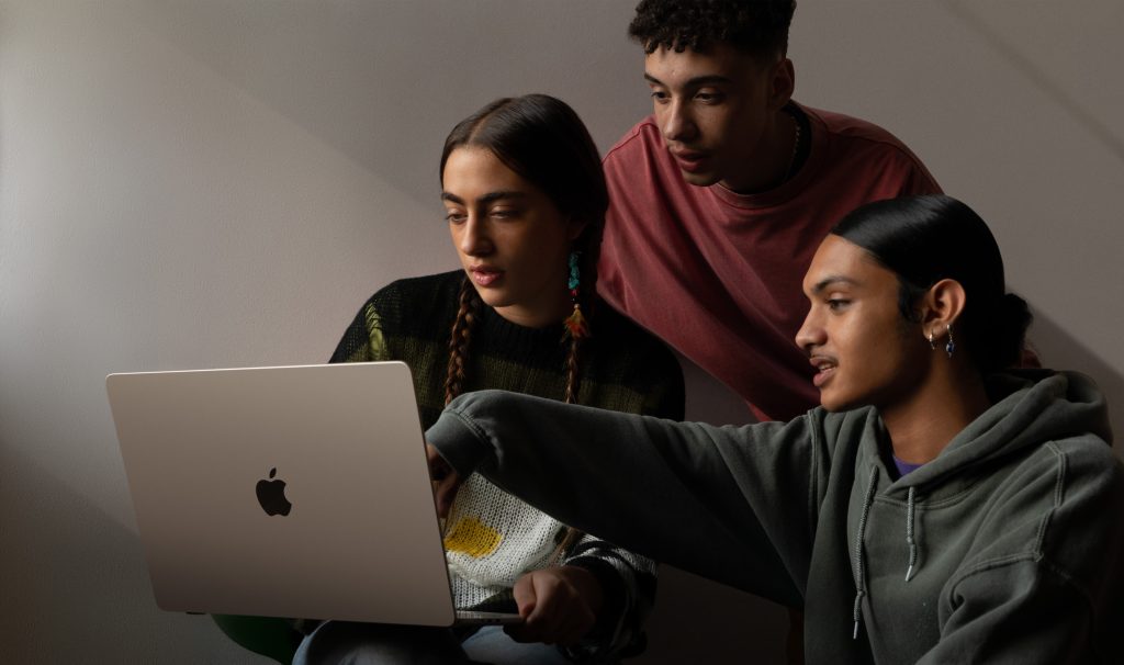 People gathered around a 15" MacBook Air M2